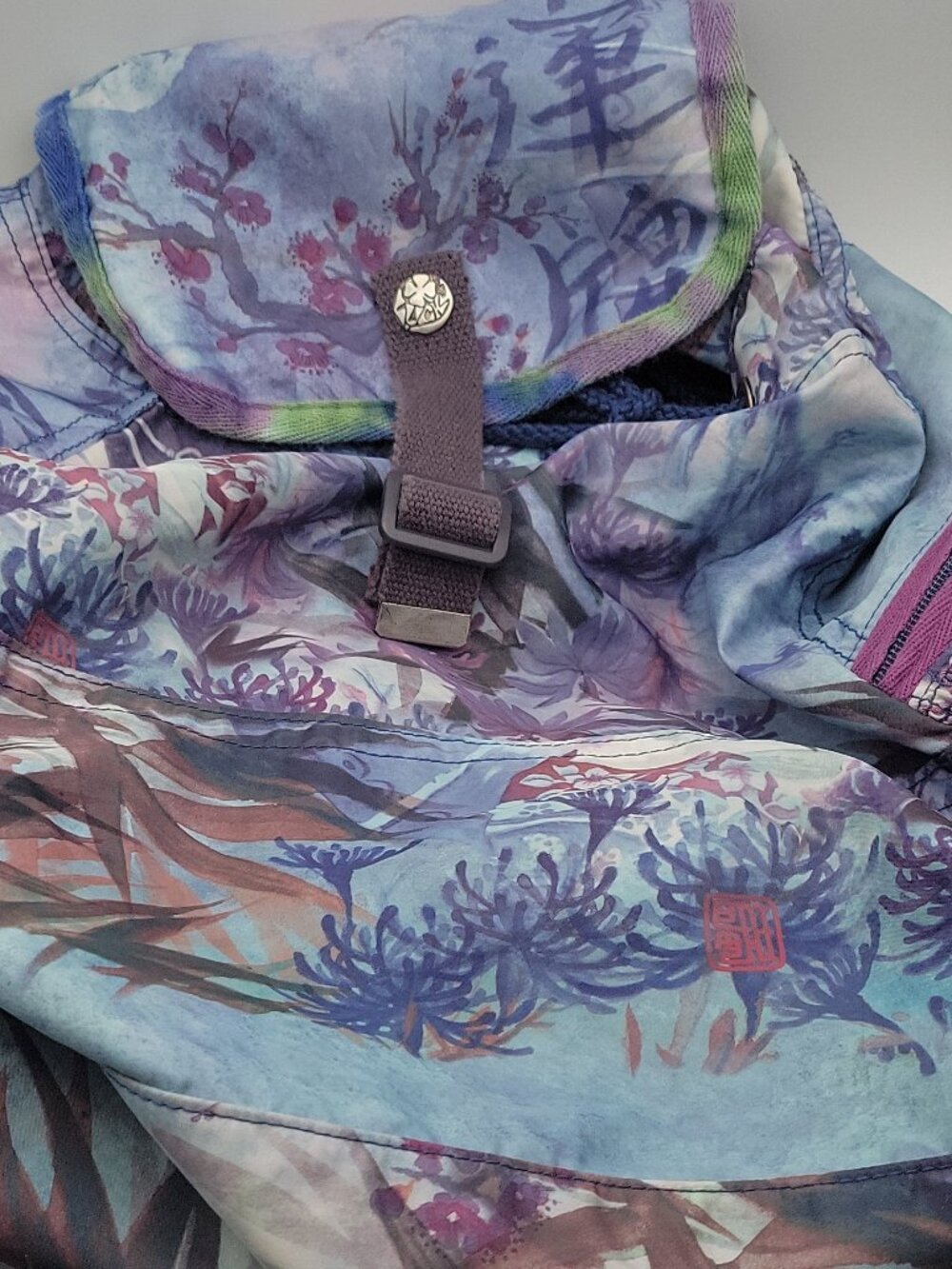 Lucky Brand floral backpack, purple accents, beaded tassel, drawstring closure